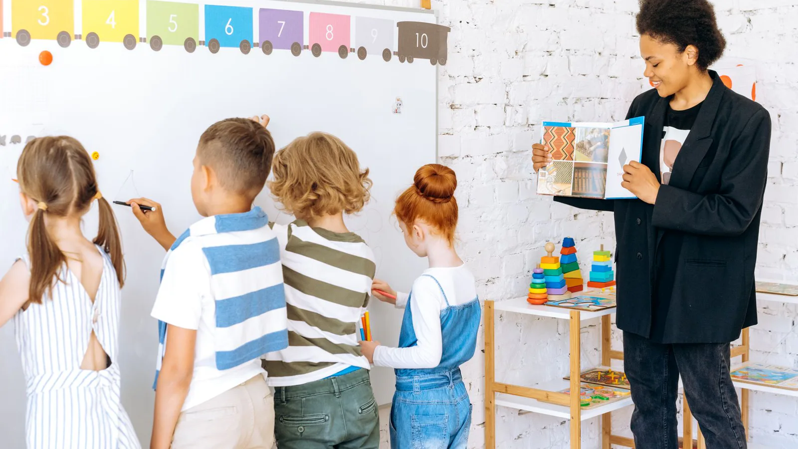 A teacher leading children through a classroom activity