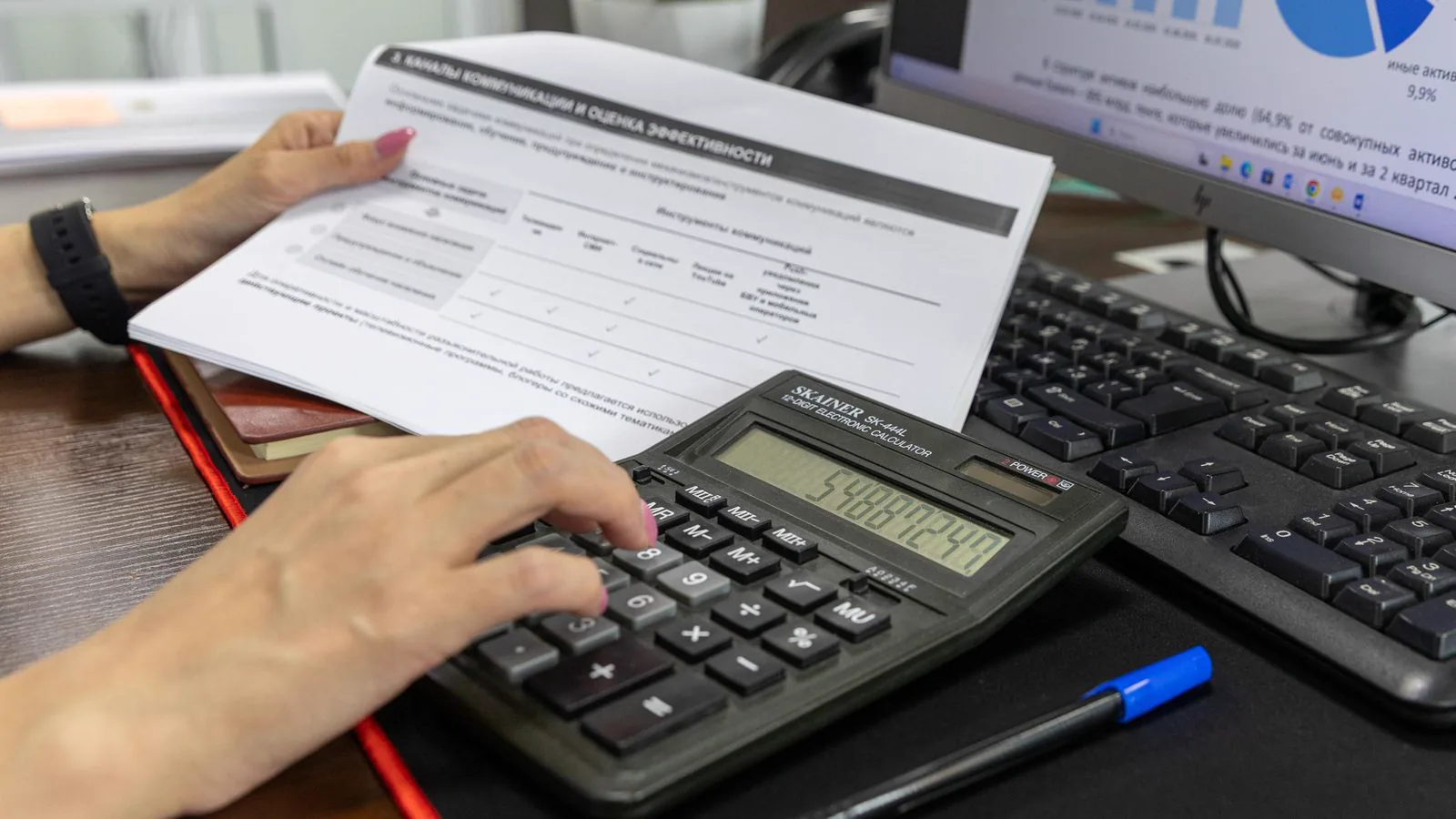 A person reviewing financial documents with a calculator