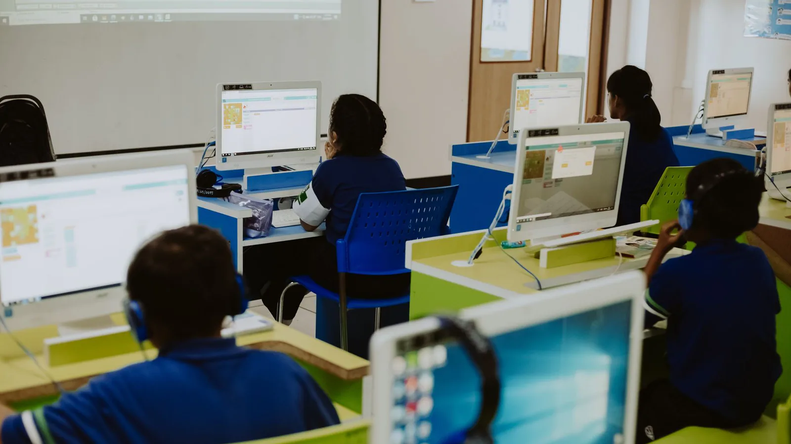 Students working at desktop computers in a classroom