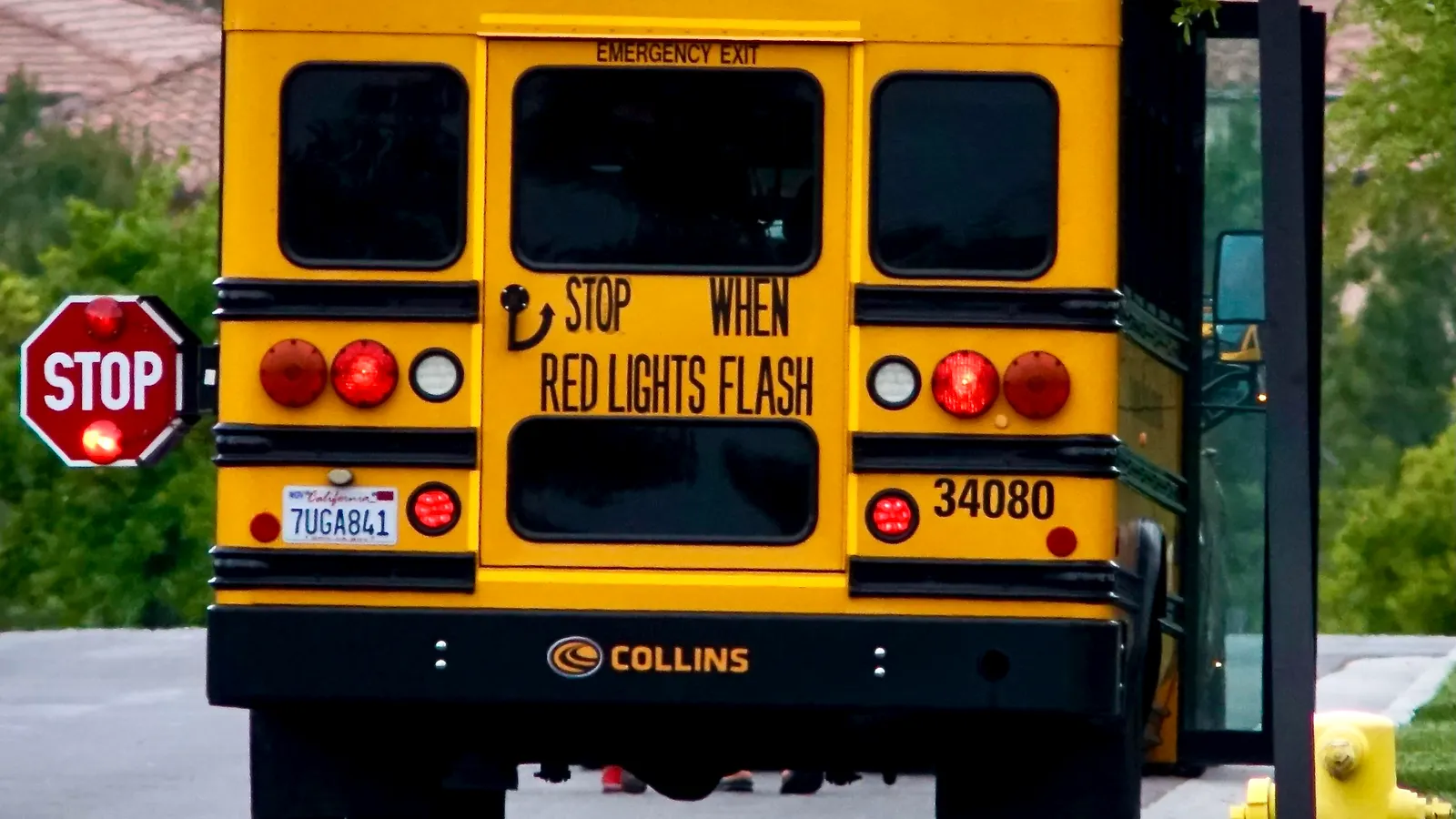 A yellow school bus on a quiet residential street