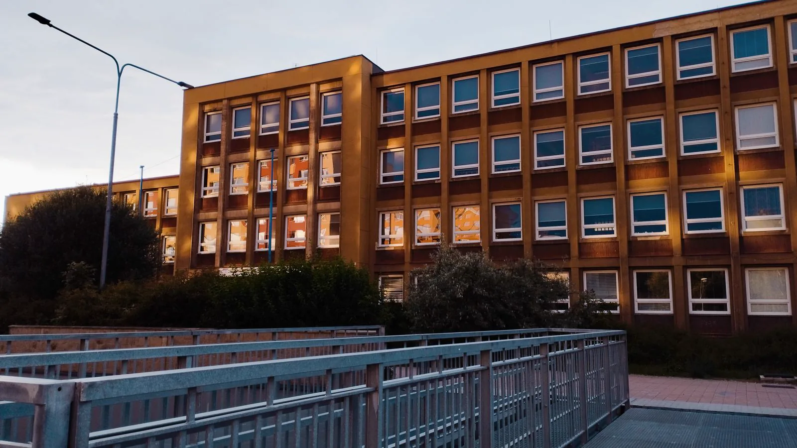 Exterior of a multi-story school building at dusk
