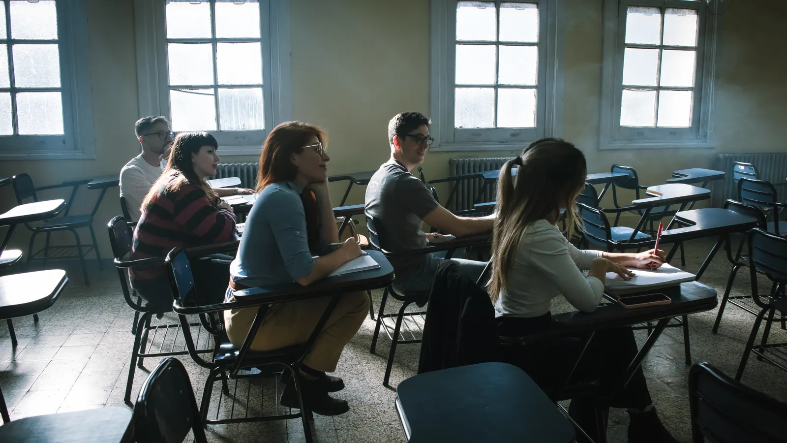 Students seated together in a classroom listening to a lesson